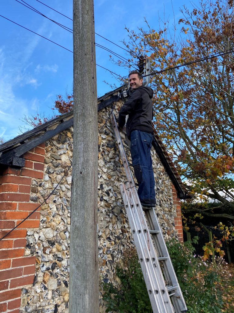Blackmore Essex Engineer working on ladders, installing VoIP infrastructure, showcasing professional setup and improved communication solutions for businesses.