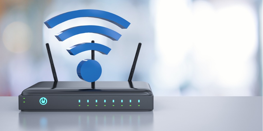 Black router on a desk with a WiFi symbol on top, showcasing a central hub for wireless connectivity and network access in a workspace.