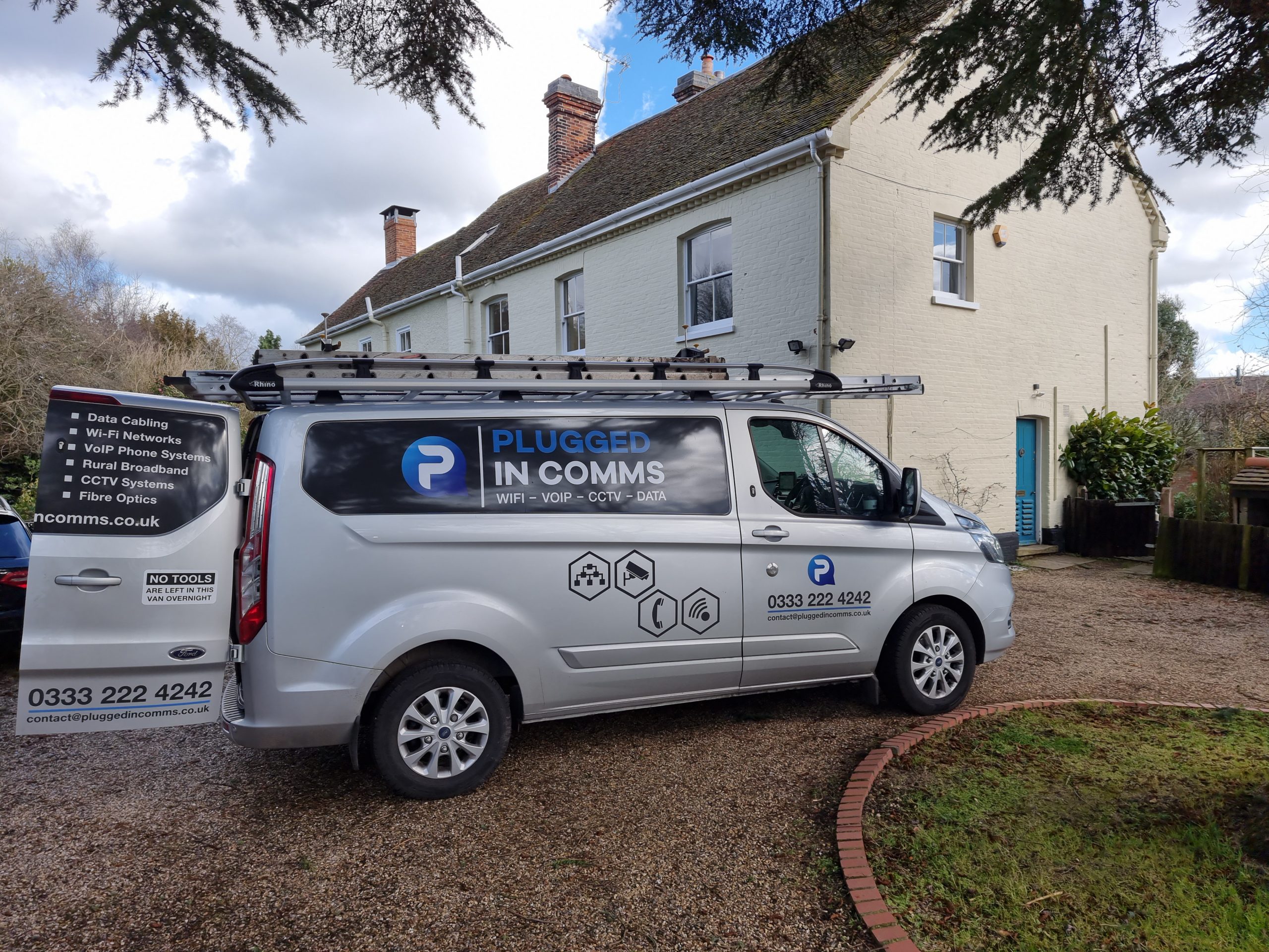 Plugged-in comms van actively working in a rural area, ensuring reliable connectivity and communication solutions for remote locations.