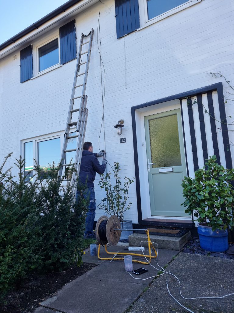 Engineer installing Wi-Fi at a residential house in Billericay Essex, ensuring seamless connectivity and enhanced internet access for modern living.