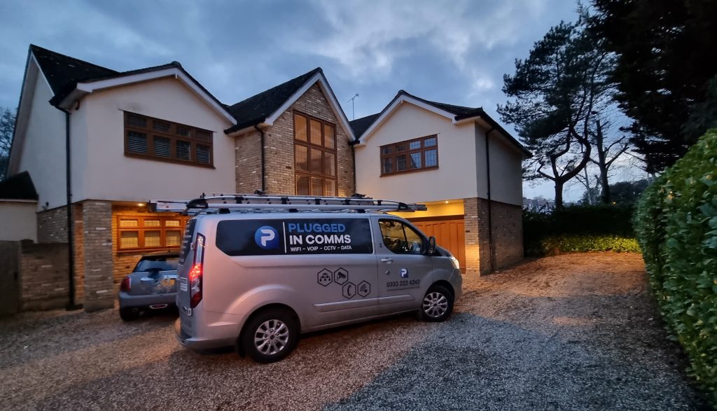 Comms van plugged in, actively working at a house in Brentwood during the night, ensuring connectivity solutions for residents.